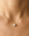 Clear string with 14k gold round 6mm white stone necklace